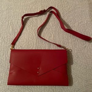 Sondra Robert’s red clutch/strap purse.